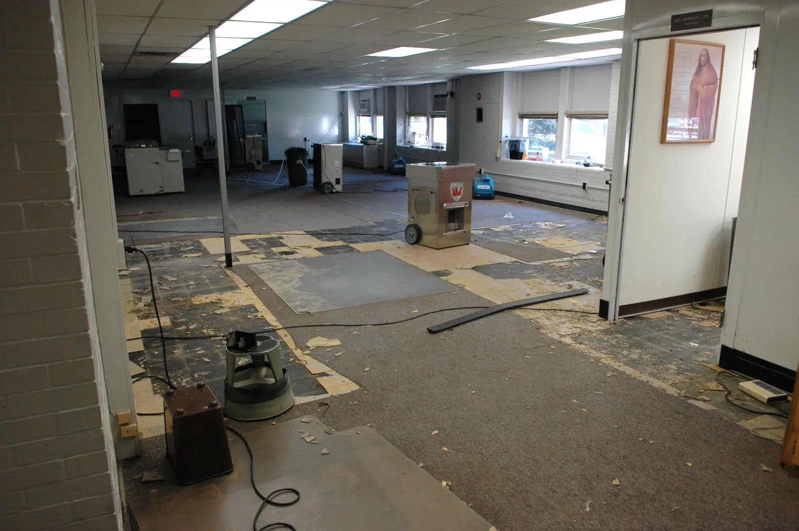 Dehumidifiers and air movers drying a water-damaged room. Shown on the Main line page for Melbourne, FL.